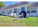Lawn view of the home's backyard with a barbecue in the background at 4207 Touchton Pl # 4207, New Port Richey, FL 34652