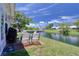 A pair of chairs overlooking a body of water with blue skies and white clouds at 4207 Touchton Pl # 4207, New Port Richey, FL 34652