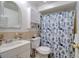 Bathroom featuring a white vanity with a sink, toilet, and shower with a nautical themed curtain at 4207 Touchton Pl # 4207, New Port Richey, FL 34652