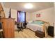 Cozy bedroom featuring a single bed, wood-look floors, and a large dresser at 4207 Touchton Pl # 4207, New Port Richey, FL 34652