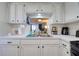 Well-lit kitchen with a view into the living room, enhancing openness and connectivity at 4207 Touchton Pl # 4207, New Port Richey, FL 34652