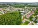 Aerial view of the home and community with mature trees, a pond, and convenient highway access at 422 Cypress View Dr, Oldsmar, FL 34677