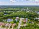 Aerial view of home within community featuring ponds, mature trees, and proximity to local amenities at 422 Cypress View Dr, Oldsmar, FL 34677