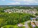 Aerial view of home showcasing community, landscaping, and nearby wooded area at 422 Cypress View Dr, Oldsmar, FL 34677