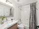 Bathroom featuring a modern vanity, white tiles and shower-tub combo at 422 Cypress View Dr, Oldsmar, FL 34677