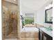 This bathroom features a large soaking tub, a glass enclosed shower, and vanity sink at 422 Cypress View Dr, Oldsmar, FL 34677