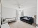 Bedroom with a couch, bed, side table, and light-colored carpet at 422 Cypress View Dr, Oldsmar, FL 34677