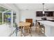 Bright breakfast nook with a table and chairs, surrounded by windows, providing views of the outdoors at 422 Cypress View Dr, Oldsmar, FL 34677
