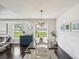 Inviting dining room with white shiplap walls, a rustic table, and views of the well-manicured backyard at 422 Cypress View Dr, Oldsmar, FL 34677