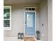 Charming front door with glass panel, welcome mat, and stylish black lanterns for a warm entrance at 422 Cypress View Dr, Oldsmar, FL 34677