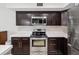 This kitchen features stainless steel appliances, brown wood cabinets and drawers, and light counter tops at 422 Cypress View Dr, Oldsmar, FL 34677