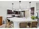 Kitchen island with white countertops, bar stool seating and pendant lighting at 422 Cypress View Dr, Oldsmar, FL 34677