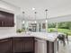 Open concept kitchen with white countertops, stainless steel appliances and view to the outdoor living area at 422 Cypress View Dr, Oldsmar, FL 34677