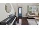 Elegant living room with a piano, dark wood floors, and a comfortable seating arrangement at 422 Cypress View Dr, Oldsmar, FL 34677