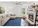 Cozy living room with a fireplace, comfortable seating, and ample natural light at 422 Cypress View Dr, Oldsmar, FL 34677