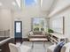 Bright and airy living room featuring high ceilings, large windows, and stylish furnishings at 422 Cypress View Dr, Oldsmar, FL 34677