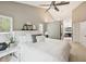 Vaulted main bedroom with a ceiling fan, bright walls, and walk-in access to the ensuite bathroom at 422 Cypress View Dr, Oldsmar, FL 34677