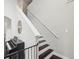 A staircase featuring dark wood treads, white risers, and a piano at the bottom of the stairs at 422 Cypress View Dr, Oldsmar, FL 34677