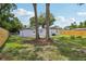 Large backyard with mature trees and partial fencing offers privacy at 4434 Perch St, Tampa, FL 33617