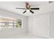Well-lit bedroom showcasing tile floors, double door closet, and a large window with blinds at 4434 Perch St, Tampa, FL 33617