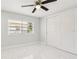 Neutral bedroom features marble floors, window, closet and fan overhead at 4434 Perch St, Tampa, FL 33617