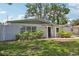 Well-maintained home featuring nice landscaping, gray and white paint, and brick accents at 4434 Perch St, Tampa, FL 33617