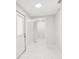 Bright hallway featuring white walls, tile floors, recessed lighting, and access to various rooms with white doors at 4434 Perch St, Tampa, FL 33617