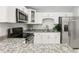 Modern kitchen features granite countertops, stainless steel appliances, and white cabinets at 4434 Perch St, Tampa, FL 33617