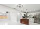 Open concept kitchen and dining room with modern lighting, island, stainless steel appliances, and sleek design at 4434 Perch St, Tampa, FL 33617