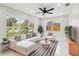 Bright living room features large windows, modern furniture, ceiling fan, and stylish black-and-white accents at 4434 Perch St, Tampa, FL 33617