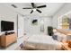 Relaxing bedroom with ceiling fan, ensuite bathroom, neutral tones, and natural light from the window at 4434 Perch St, Tampa, FL 33617