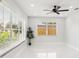 Bright room with large windows and a modern ceiling fan, providing ample natural light and a fresh atmosphere at 4434 Perch St, Tampa, FL 33617