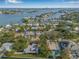 An aerial shot shows a neighborhood of waterfront homes, revealing a home with a private pool at 4495 Clearwater Harbor S Dr, Largo, FL 33770