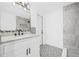 Modern bathroom features a stylish vanity, contemporary fixtures, and decorative gray and white patterned floor tiles at 4495 Clearwater Harbor S Dr, Largo, FL 33770