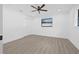 Bright bedroom with neutral walls, laminate flooring, a ceiling fan, and a double-door closet at 4495 Clearwater Harbor S Dr, Largo, FL 33770