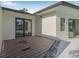 Stylish modern home with a wood deck leading to sliding glass doors, and gravel landscaping at 4495 Clearwater Harbor S Dr, Largo, FL 33770