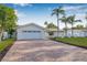 Charming home with a well manicured lawn and brick driveway and front entrance and attractive landscaping at 4495 Clearwater Harbor S Dr, Largo, FL 33770
