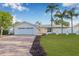 Charming home with a well manicured lawn and brick driveway and front entrance and attractive landscaping at 4495 Clearwater Harbor S Dr, Largo, FL 33770