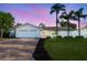 Charming home with a well manicured lawn and brick driveway and front entrance and attractive landscaping at 4495 Clearwater Harbor S Dr, Largo, FL 33770