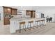 Modern eat-in kitchen boasts a large island, stainless steel appliances, stylish bar stools, and wooden cabinets at 4495 Clearwater Harbor S Dr, Largo, FL 33770