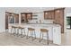 Modern eat-in kitchen boasts a large island, stainless steel appliances, stylish bar stools, and wooden cabinets at 4495 Clearwater Harbor S Dr, Largo, FL 33770