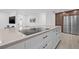 Close up showcasing the large kitchen island with a sleek cooktop, ample storage, and modern finishes at 4495 Clearwater Harbor S Dr, Largo, FL 33770