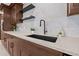 A closer view of the modern kitchen sink and quartz countertops, complemented by stylish backsplash and floating shelves at 4495 Clearwater Harbor S Dr, Largo, FL 33770