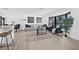 Bright living room with large window, modern furniture, and light wood flooring and neutral color scheme at 4495 Clearwater Harbor S Dr, Largo, FL 33770