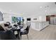 Open floor plan showcasing a spacious living area with modern furnishings and a large island kitchen with stainless appliances at 4495 Clearwater Harbor S Dr, Largo, FL 33770