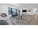 Bright living room with a large bay window, modern decor, and sleek hardwood flooring offers a cozy and inviting atmosphere at 4495 Clearwater Harbor S Dr, Largo, FL 33770