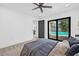 Serene bedroom with a view of the pool through large glass doors, featuring modern decor and a relaxing ambiance at 4495 Clearwater Harbor S Dr, Largo, FL 33770