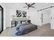 Modern bedroom featuring a comfortable bed, stylish decor, and a sliding barn door leading to the ensuite bathroom at 4495 Clearwater Harbor S Dr, Largo, FL 33770