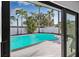 Backyard pool and lanai view from inside at 4495 Clearwater Harbor S Dr, Largo, FL 33770
