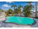 A private pool is surrounded by swaying palms, creating a tranquil oasis at 4495 Clearwater Harbor S Dr, Largo, FL 33770
